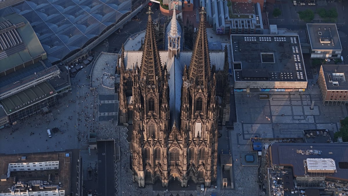 Aerial view of Cologne Cathedral in Germany, showcasing its Gothic architecture amidst the urban landscape