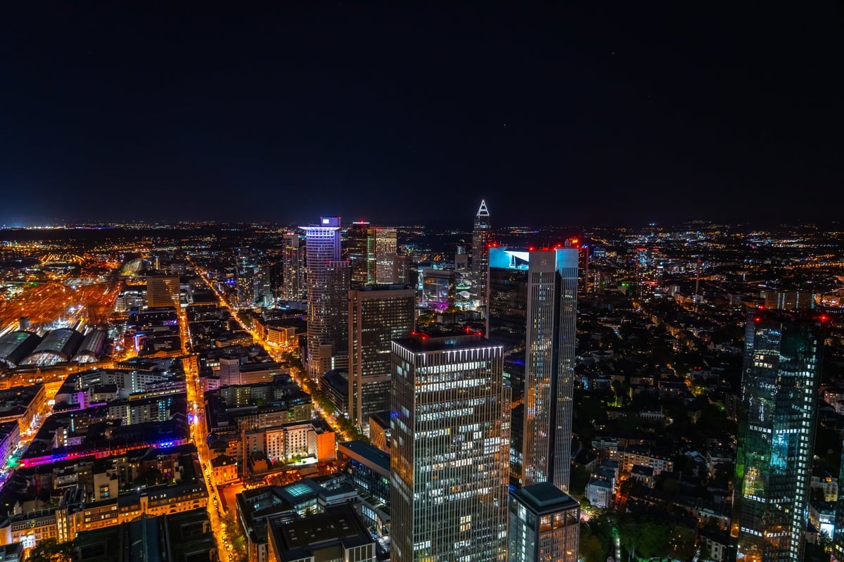 Frankfurt skyline at night, showcasing modern skyscrapers illuminated against the dark sky